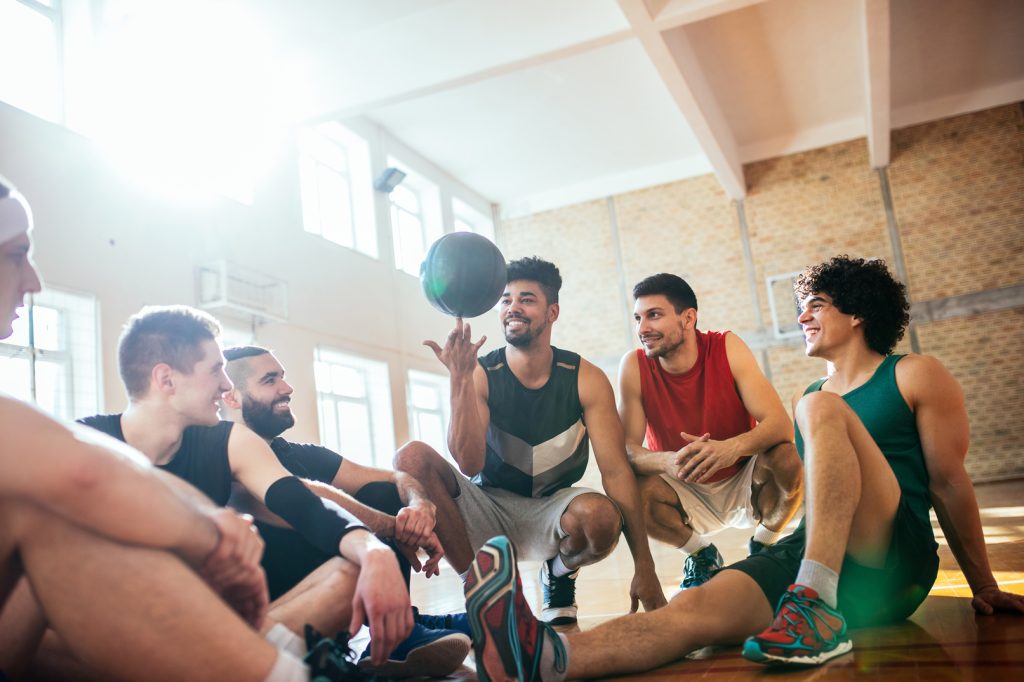 Apartments in Lebanon Group of basketball players taking a break and interacting in a gymnasium.