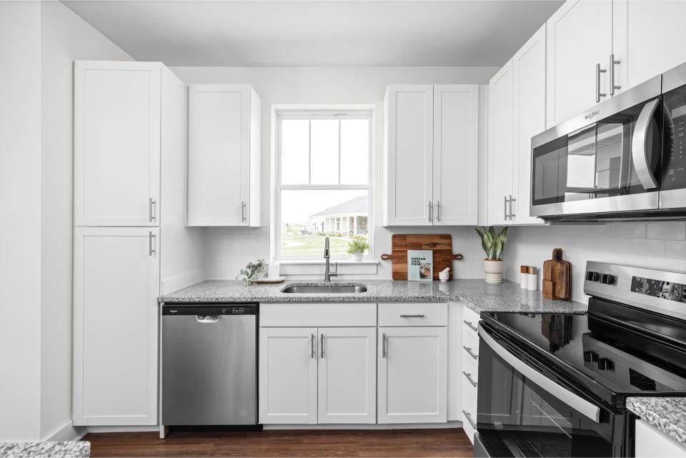 Indiana, Boone County, Lebanon Apartments for rent Modern kitchen with white cabinets, granite countertops, stainless steel appliances, a window above the sink, and wooden floor. See all available apartments for rent at Hickory Cottages in Indiana Boone County Lebanon, Hickory Cottages has rental units ranging from 664-1420 sq ft