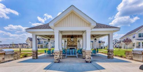 See all available apartments for rent at Hickory Cottages in Lebanon, IN. Hickory Cottages has rental units ranging from 664-1420 sq ftOutdoor pavilion with a gabled roof, picnic tables, and BBQ grills. It is surrounded by a grassy area with houses in the background under a clear blue sky.