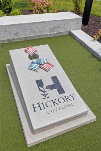 Indiana, Boone County, Lebanon Apartments for rent A cornhole board labeled Hickory Cottages with four bean bags, two red and two blue with stars and stripes, on artificial turf. See all available apartments for rent at Hickory Cottages in Indiana Boone County Lebanon, Hickory Cottages has rental units ranging from 664-1420 sq ft