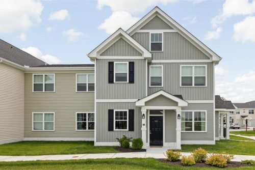 Indiana, Boone County, Lebanon Apartments for rent Two-story suburban house with gray siding, white trim, black shutters, and a small front porch, surrounded by a lawn and shrubs under a partly cloudy sky. See all available apartments for rent at Hickory Cottages in Indiana Boone County Lebanon, Hickory Cottages has rental units ranging from 664-1420 sq ft