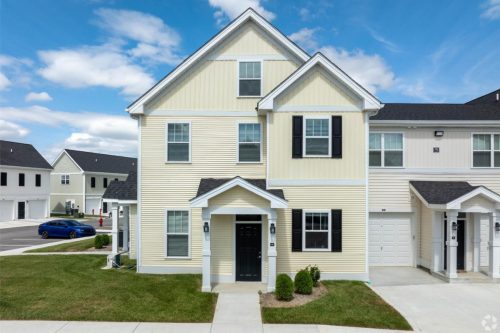 Indiana, Boone County, Lebanon Apartments for rent Two-story, light yellow townhouse with black shutters and a small front porch, situated in a suburban neighborhood with paved driveways and green lawns. See all available apartments for rent at Hickory Cottages in Indiana Boone County Lebanon, Hickory Cottages has rental units ranging from 664-1420 sq ft