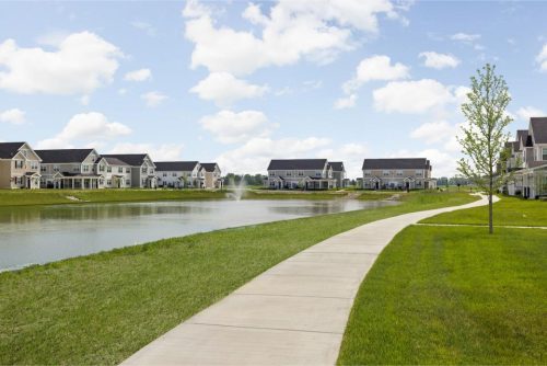 Indiana, Boone County, Lebanon Apartments for rent A curved sidewalk runs alongside a pond with a fountain, bordered by green lawns and rows of suburban houses under a partly cloudy sky. See all available apartments for rent at Hickory Cottages in Indiana Boone County Lebanon, Hickory Cottages has rental units ranging from 664-1420 sq ft
