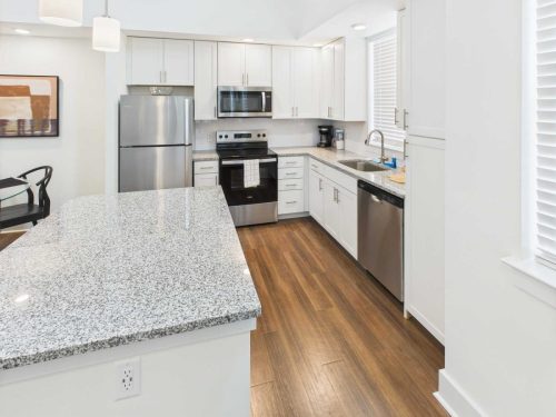 Indiana, Boone County, Lebanon Apartments for rent Modern kitchen with white cabinets, stainless steel appliances, granite countertops, wood flooring, and a large island. See all available apartments for rent at Hickory Cottages in Indiana Boone County Lebanon, Hickory Cottages has rental units ranging from 664-1420 sq ft