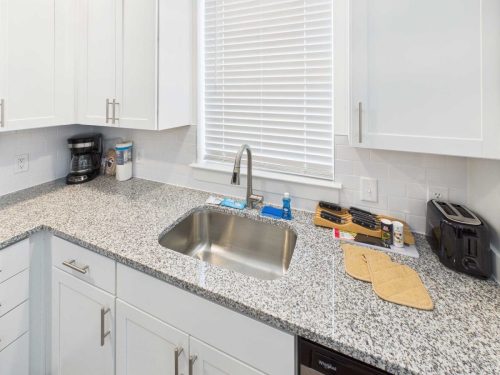 Indiana, Boone County, Lebanon Apartments for rent A kitchen countertop with a sink, coffee maker, toaster, dish soap, sponges, cutting boards, and oven mitts under a window with closed blinds. See all available apartments for rent at Hickory Cottages in Indiana Boone County Lebanon, Hickory Cottages has rental units ranging from 664-1420 sq ft
