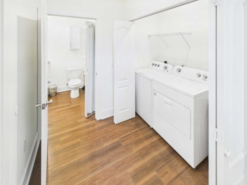 Indiana, Boone County, Lebanon Apartments for rent A laundry room with a washing machine and dryer, open double doors, and an adjacent bathroom visible in the background. See all available apartments for rent at Hickory Cottages in Indiana Boone County Lebanon, Hickory Cottages has rental units ranging from 664-1420 sq ft