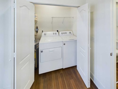 Indiana, Boone County, Lebanon Apartments for rent A laundry closet with white folding doors, containing a white top-loading washing machine and dryer, water heater, and a wire shelf above them. See all available apartments for rent at Hickory Cottages in Indiana Boone County Lebanon, Hickory Cottages has rental units ranging from 664-1420 sq ft