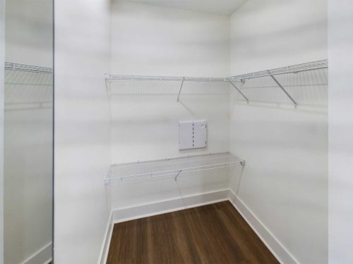 Indiana, Boone County, Lebanon Apartments for rent Empty walk-in closet with white walls, three wire shelves, hardwood flooring, and a small utility panel on the back wall. See all available apartments for rent at Hickory Cottages in Indiana Boone County Lebanon, Hickory Cottages has rental units ranging from 664-1420 sq ft