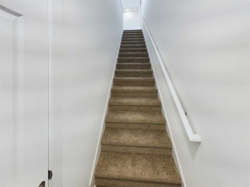 Indiana, Boone County, Lebanon Apartments for rent A straight staircase with brown carpet and white walls, featuring a white handrail on the right side, leads up to a bright landing. See all available apartments for rent at Hickory Cottages in Indiana Boone County Lebanon, Hickory Cottages has rental units ranging from 664-1420 sq ft