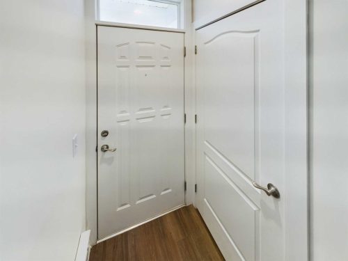 Indiana, Boone County, Lebanon Apartments for rent White entry door with a silver handle and lock, sidelined by a white interior door, both set against light-colored walls and brown wood flooring. See all available apartments for rent at Hickory Cottages in Indiana Boone County Lebanon, Hickory Cottages has rental units ranging from 664-1420 sq ft
