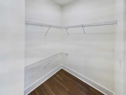 Apartments in Lebanon, IN Empty walk-in closet with white walls, metal wire shelving, and wooden floor.