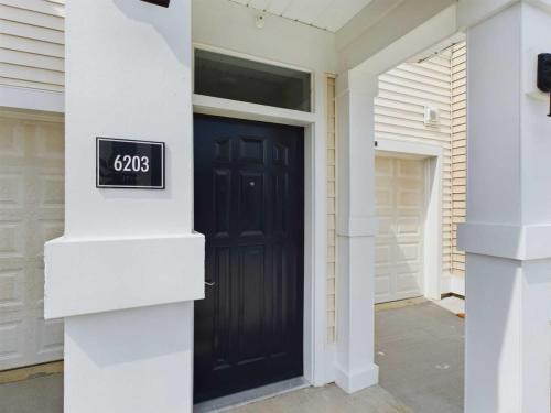 Apartments in Lebanon, IN Front view of a house with black door, white trim, and address number 6203 displayed on a plaque to the left of the door—ideal for those seeking apartments for rent in Lebanon, Indiana.