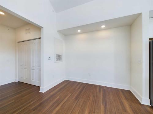 Apartments in Lebanon, IN Empty room with wooden floors, white walls, recessed lighting, and a closet with double doors on the left.