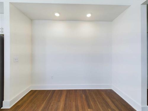 Apartments in Lebanon, IN Small, empty, white-walled room with wooden floors and two recessed ceiling lights.