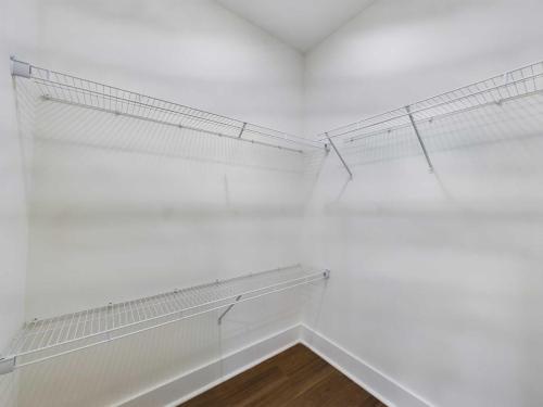 Apartments in Lebanon, IN Empty white closet with wire shelving and a wooden floor.