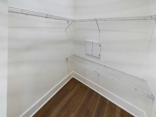 Indiana, Boone County, Lebanon Apartments for rent Empty walk-in closet with white walls, wire shelving on two sides, and wooden flooring. See all available apartments for rent at Hickory Cottages in Indiana Boone County Lebanon, Hickory Cottages has rental units ranging from 664-1420 sq ft