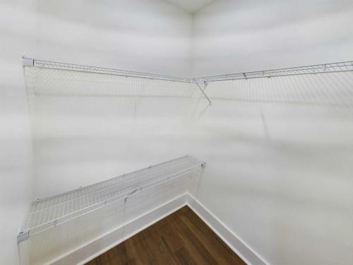 Indiana, Boone County, Lebanon Apartments for rent Empty closet with white wire shelving on three walls and wood flooring. See all available apartments for rent at Hickory Cottages in Indiana Boone County Lebanon, Hickory Cottages has rental units ranging from 664-1420 sq ft