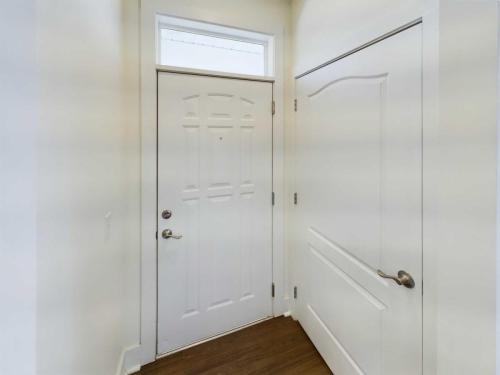 Indiana, Boone County, Lebanon Apartments for rent A hallway with a white front door, a side door, and hardwood flooring. See all available apartments for rent at Hickory Cottages in Indiana Boone County Lebanon, Hickory Cottages has rental units ranging from 664-1420 sq ft